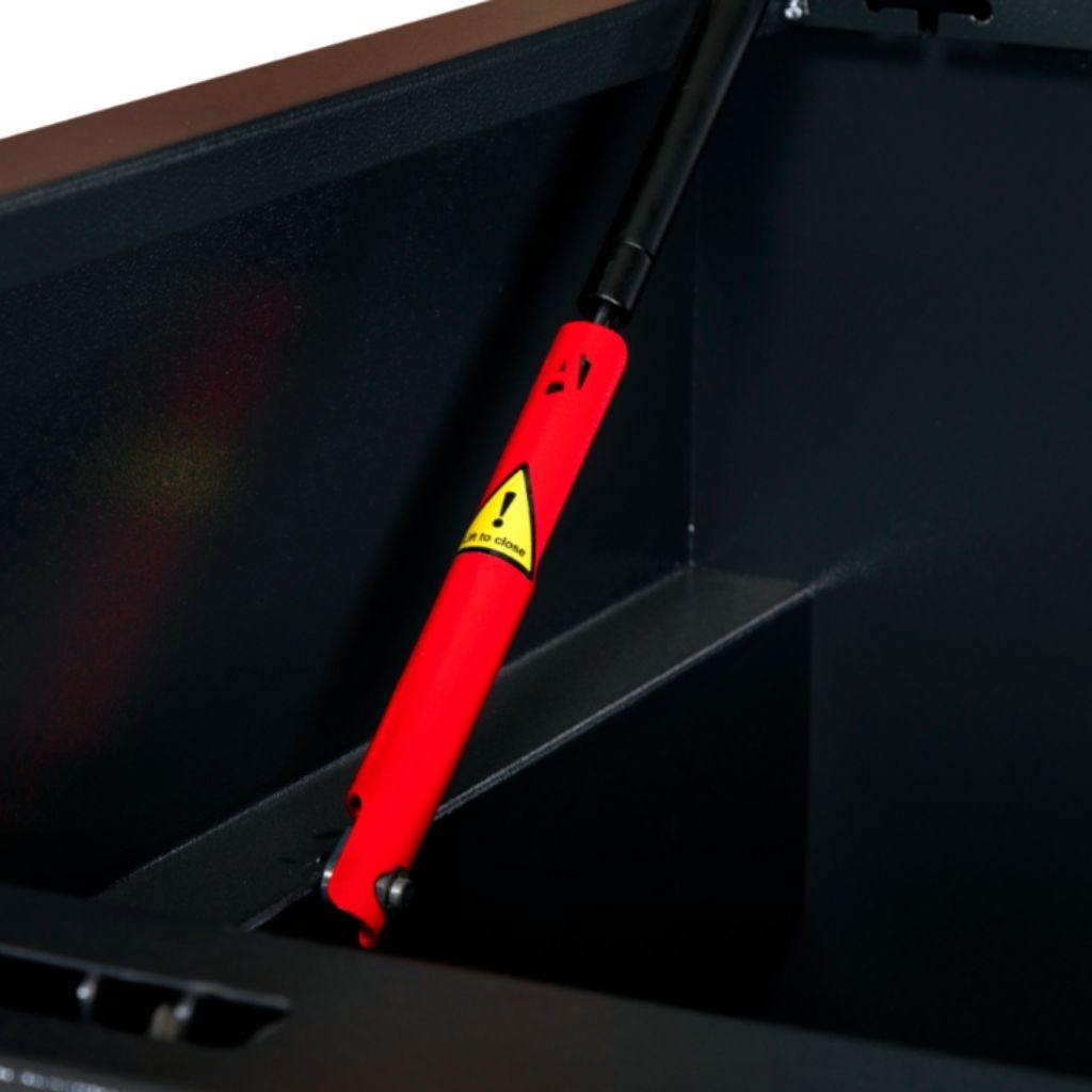 Red shock absorber on an armorgard sb24 siteboss chest with a yellow warning label on a black background.