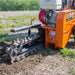 Orange brave pro 18 trencher on a field with grass and small flowers.