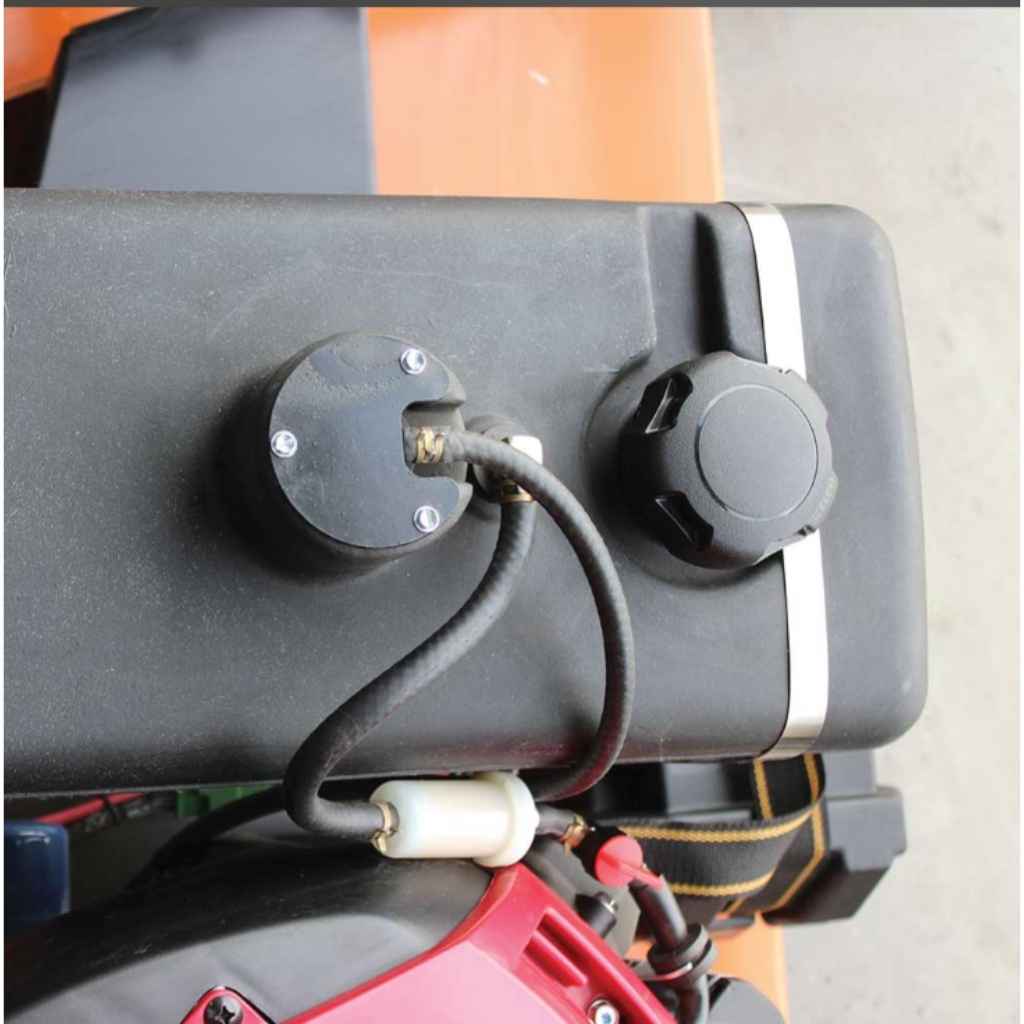 Close-up of a mechanical component  on a brave 60 inch tow behind finish cut mower with wiring on a vehicle, showing a focus on detail.