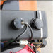 Close-up of a mechanical component  on a brave 60 inch tow behind finish cut mower with wiring on a vehicle, showing a focus on detail.