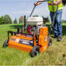 Person using a Brave dethatcher on grass