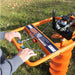 Orange Bravepro Towable Auger with 'Brave Pro' branding on a grassy background