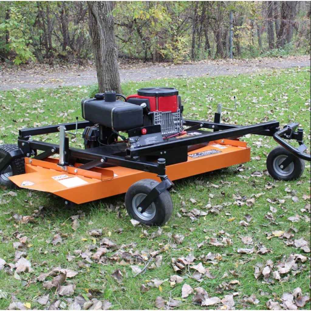 Orange brave finish cut tow behind 60 inch mower with engine on a grassy area with fallen leaves