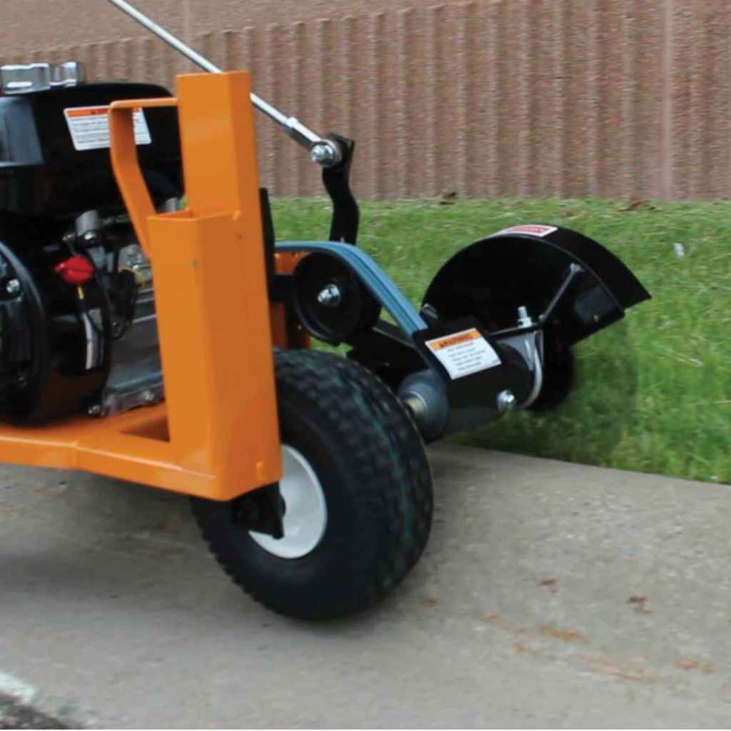 Orange brave star blade edger on a concrete surface with grass in the background