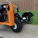 Orange brave star blade edger on a concrete surface with grass in the background