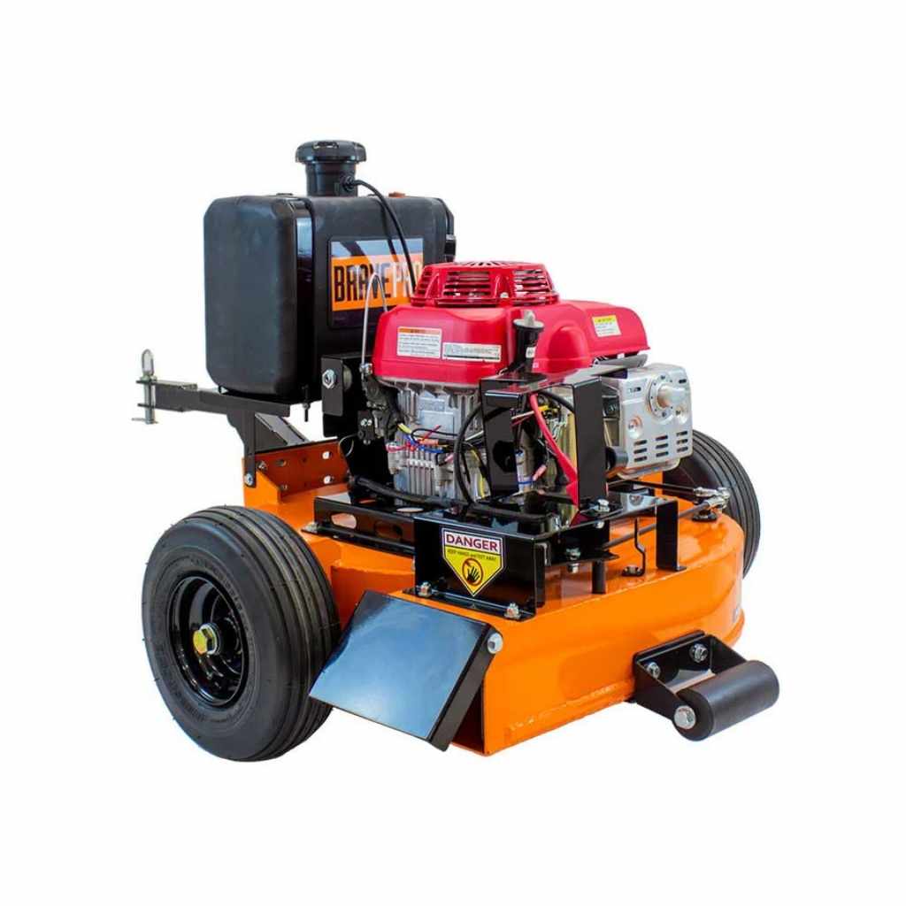 Orange and black Brave tow behind leaf blower with a red engine on a white background