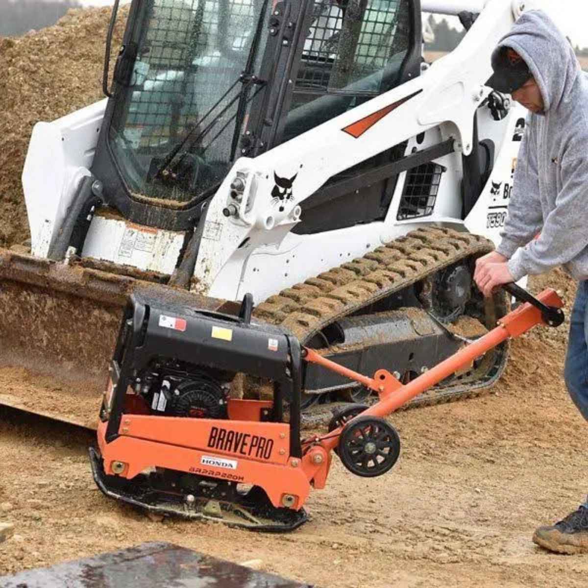 Person operating a bravepro 20in reversible plate compactor  on a construction site.