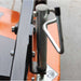 Close-up of a metal lever on a brave pro finish cut tow behind 60 inch mower on a gray background