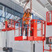 person  reaching a tall structure while on a bravi leonardo scissor lift on a factory setting