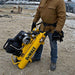 Person holding a yellow Dewalt 8 gal 5.7cfm wheelbarrow air compressor on a construction site