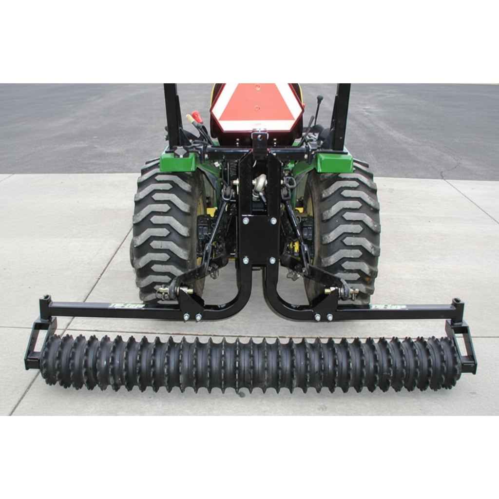 Tractor with a black Greywolf towable cultipacker on a gray surface