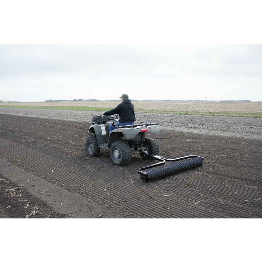 Person operating a ATV with a Greywolf Cultipacker Till N Claw in a field