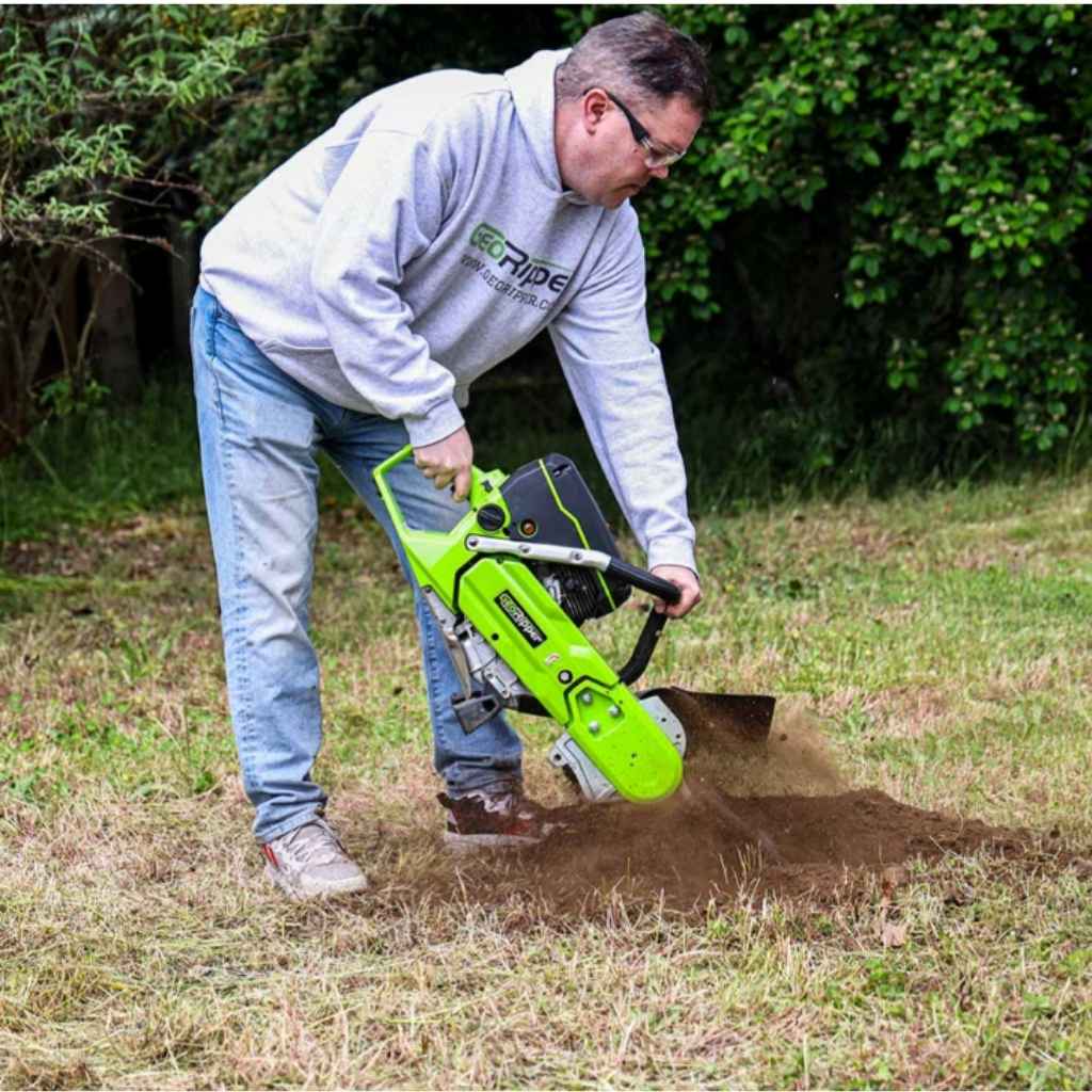 person operating a georipper trencher for sale in a grassy yard with trees in the background during the day.