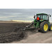 Green tractor plowing a field with a greywolf 3 point chisel plow & cultivator a cloudy sky in the background