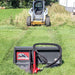 Skid steer loader with a Greywolf tree puller attachment on grassy field