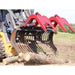 Skid steer loader with a greywolf skid steer quick attach grapple attachment cutting through a log in an outdoor setting.