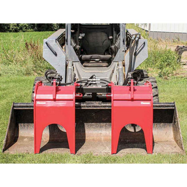 Red greywolf quick attach skid steer grapple on a skid steer loader in an outdoor setting