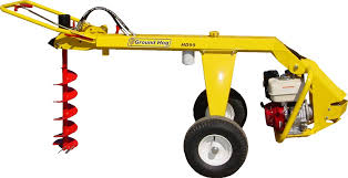 Yellow GroundHog HD99 one-man towable earth drill with a drill bit attachment on a white background