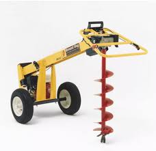 Yellow and black GroundHog HD99 one-man towable earth drill on a white background