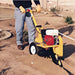 Person using a yellow groundhog t4 on a dirt road.