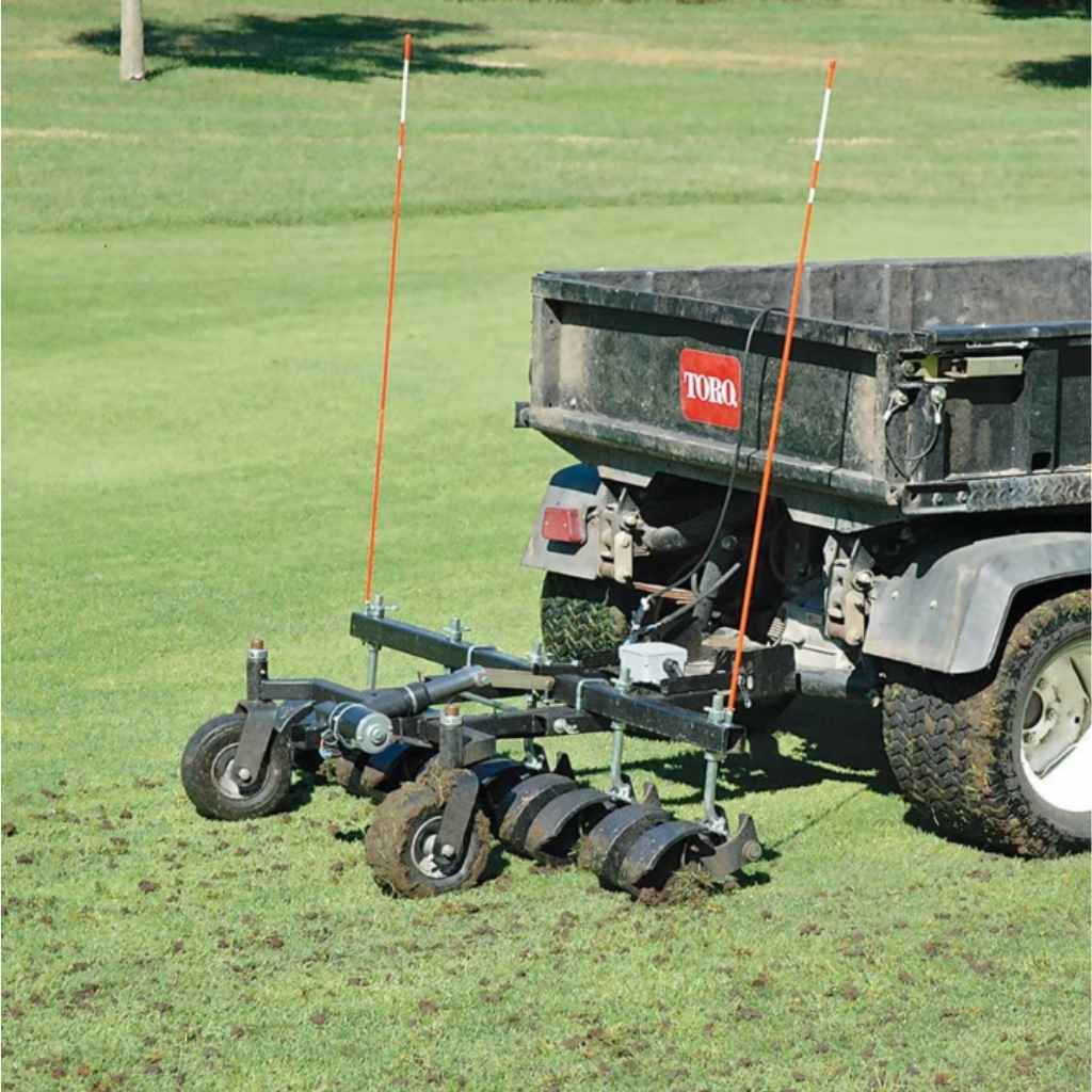 Trailer with Jrco 60 inch tow behind hooker aerator on a grassy field