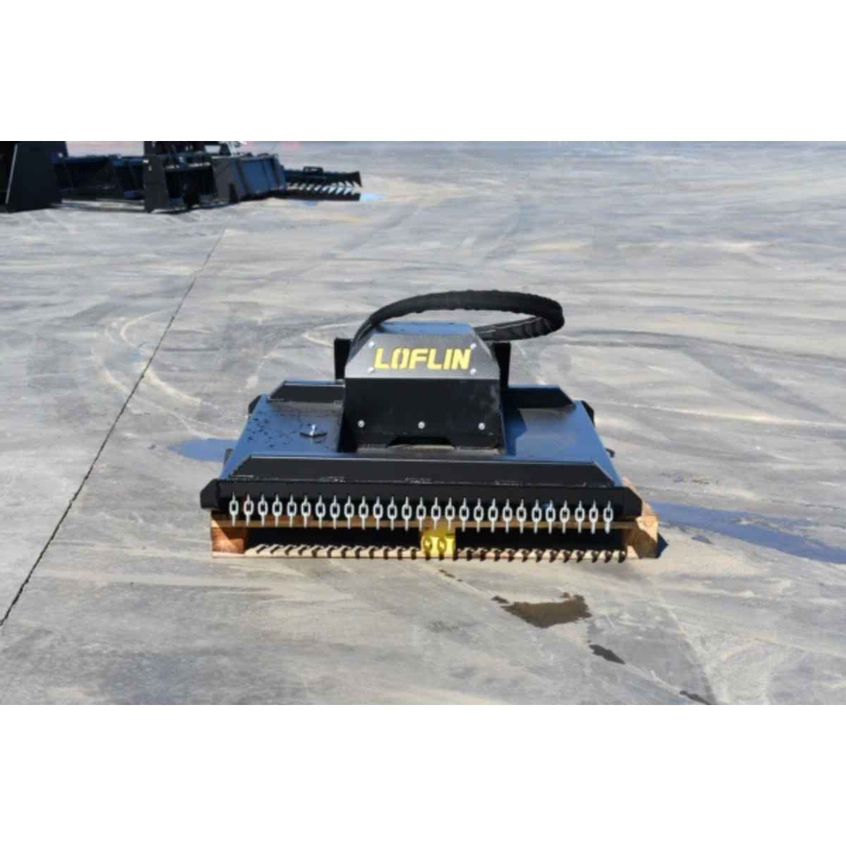 A black LOFLIN fabrication mini skid steer brush cutter attachment with a prominent yellow brand logo, positioned on a gray concrete surface.