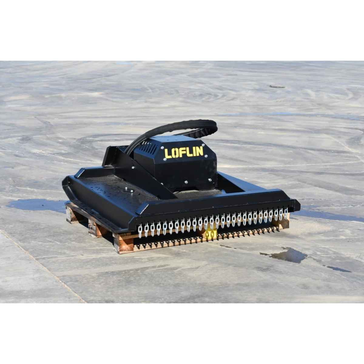 A black mini skid steer brush cutter by loflin with the brand name LOFLIN in yellow on the side, positioned on a gray concrete floor.