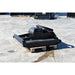 A black loflin mini skid steer brush cutter resting on a wooden pallet on a concrete surface.