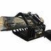 Black Loflin Mini Skid Steer Root Grapple holding a log on a white background