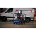 A blue and red Makinex 32 kw Generator 480 V on wheels in a factory setting on a cement floor with a white Makinex Van in the background 
