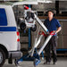 Person using a makinex hand truck to load a generator into the back of a van