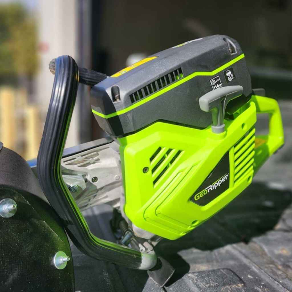 close up of the handle of a mini trencher georipper sitting in the bed of a truck