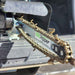 Close up of the chain of a georipper mini trencher sitting in the bed of a truck