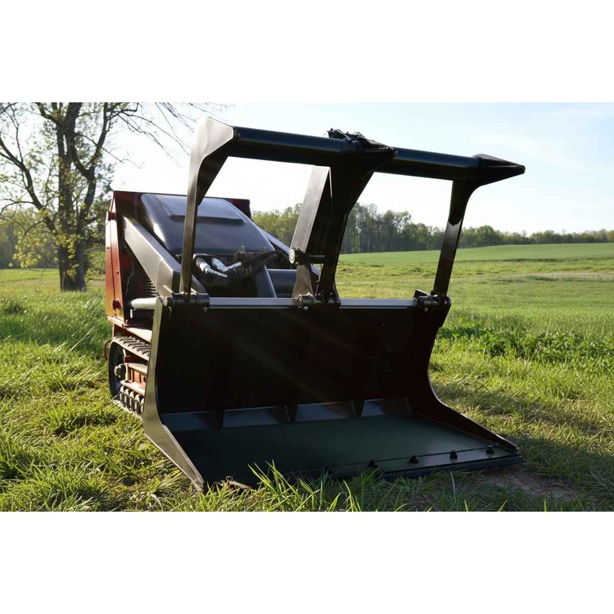 Bobcat mini skid-steer loader with a loflin mini skid steer grapple in a grassy field