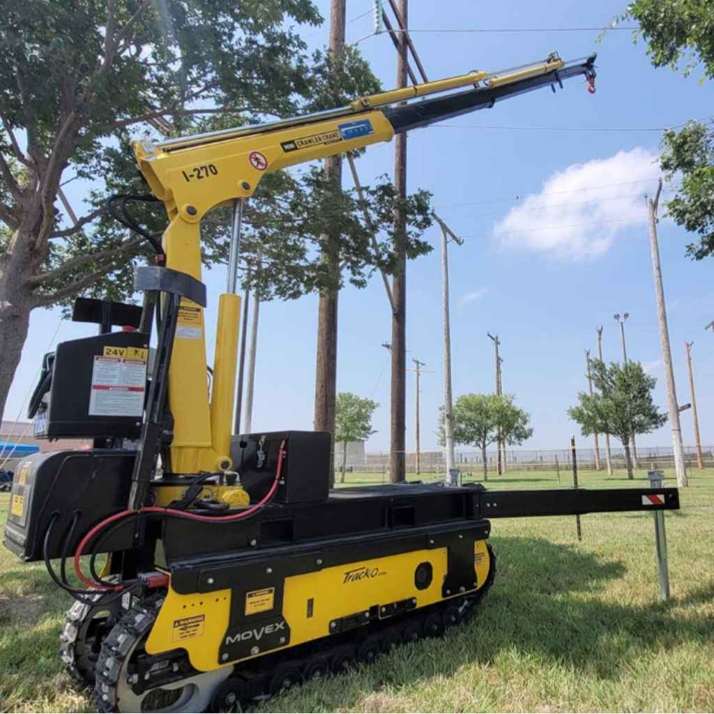 Yellow and black Movex Mini Crawler Xc-270 with arm in an outdoor setting