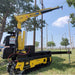 Yellow and black Movex Mini Crawler Xc-270 with arm in an outdoor setting