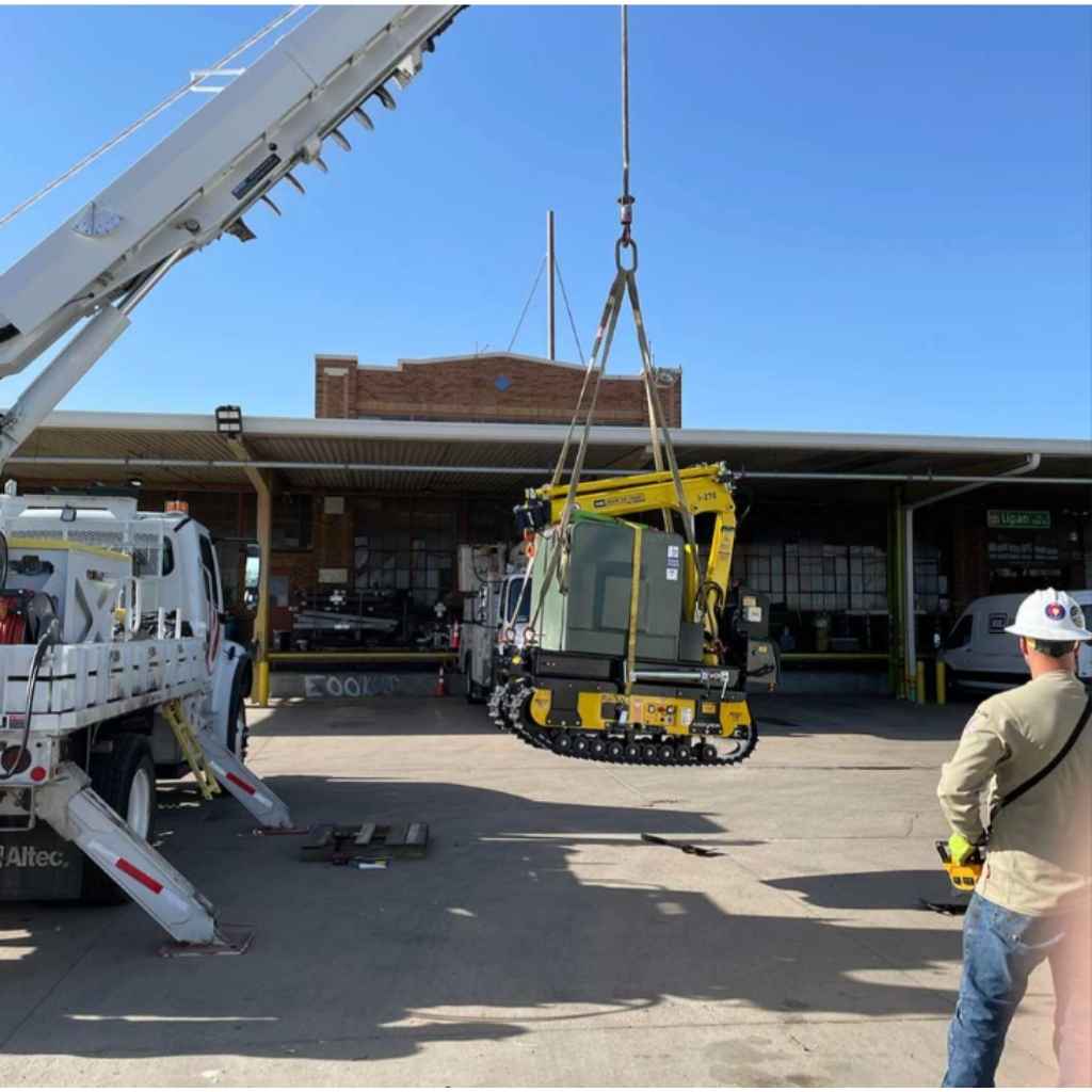 Movex Mini Crawler Crane being lowered down by another crane with clear skies during the day