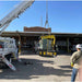 Movex Mini Crawler Crane being lowered down by another crane with clear skies during the day