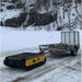 Yellow movex tracked xc 48 towing a trailer on a snowy path