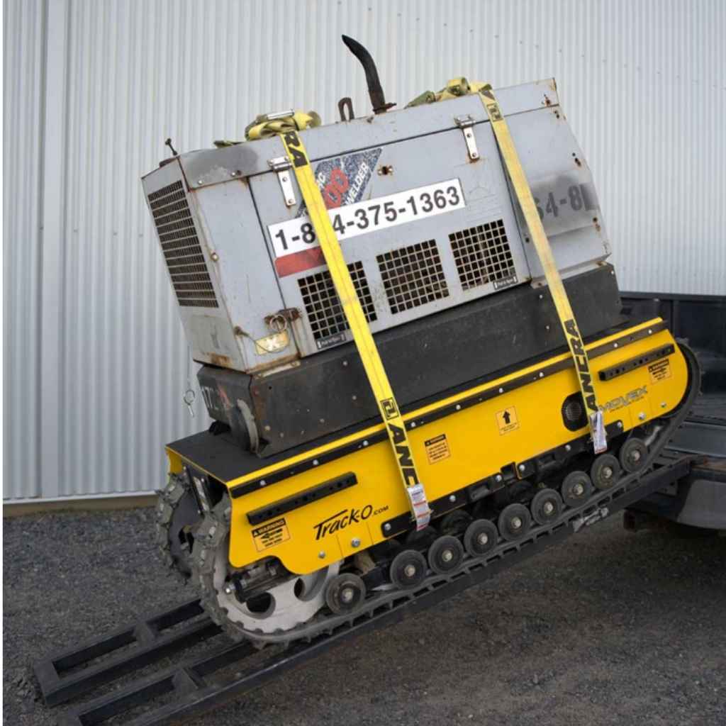 Yellow and black movex cross country tracked carrier xc 30 on a concrete floor with a gray wall background