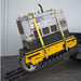 Yellow and black movex cross country tracked carrier xc 30 on a concrete floor with a gray wall background