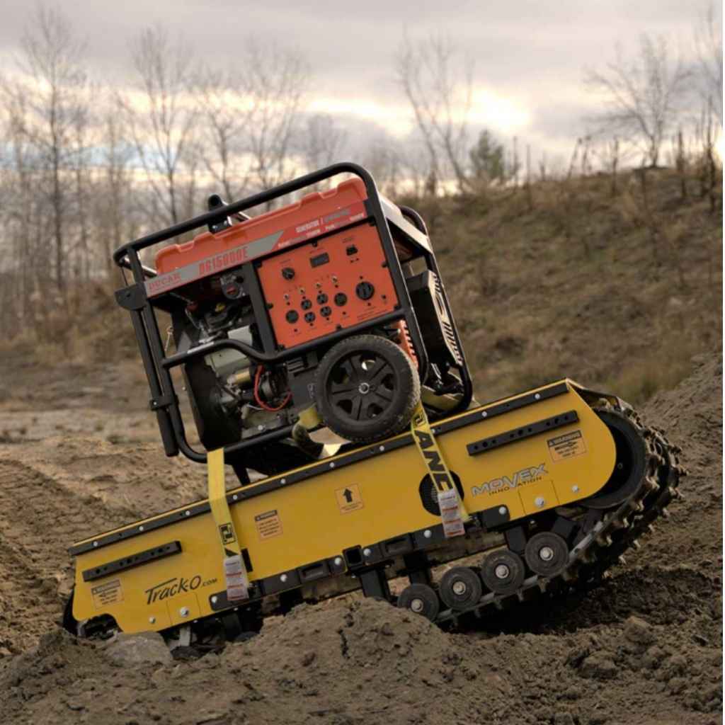 Small movex xc 30 all terrain carrier on a dirt surface with a scenic background