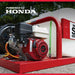 Honda-powered Northstar 100 gallon capacity skid sprayer with a red frame and visible engine, set against a natural background.
