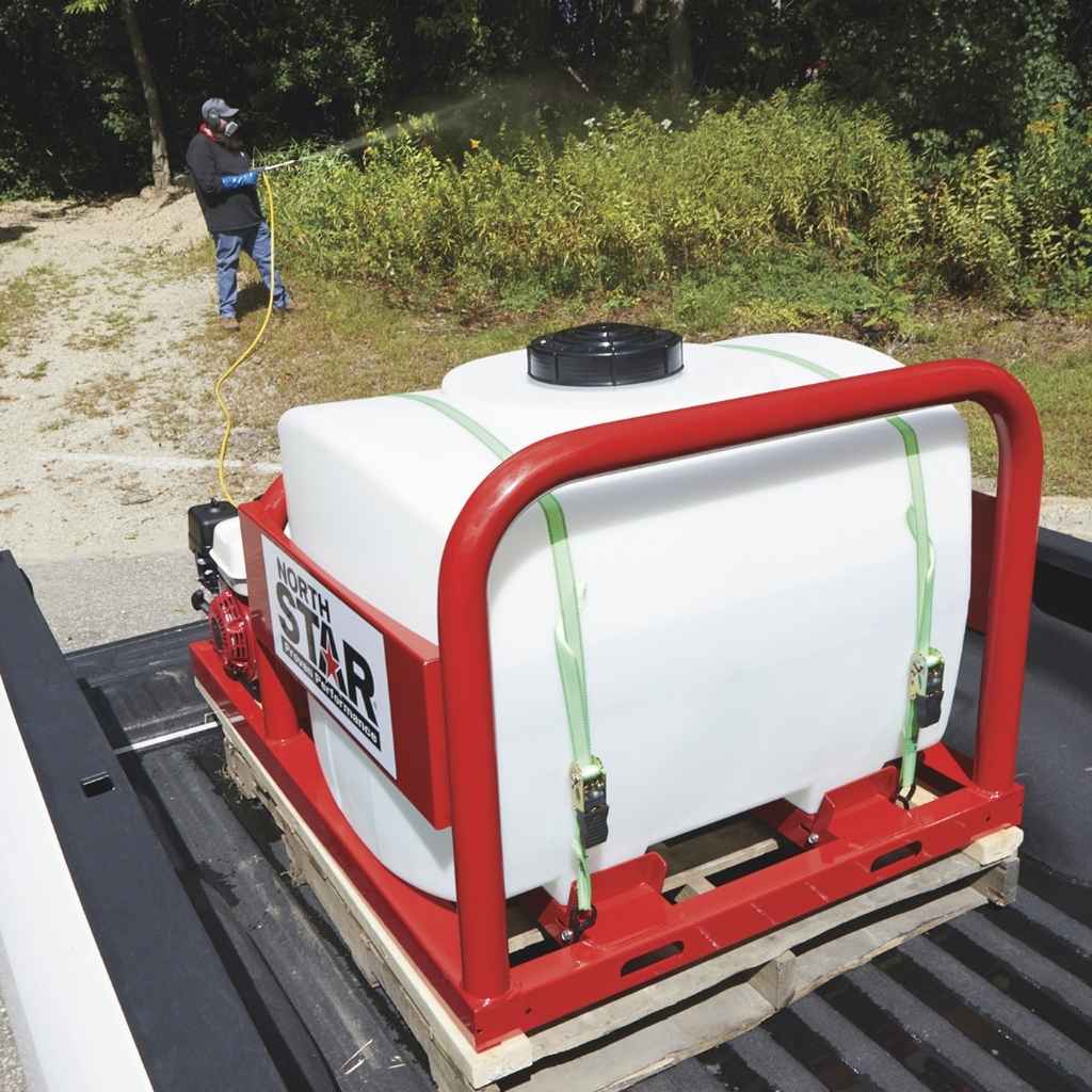 Person using a North Star 100 gallon sprayer on a vehicle with a large white tank and red frame.