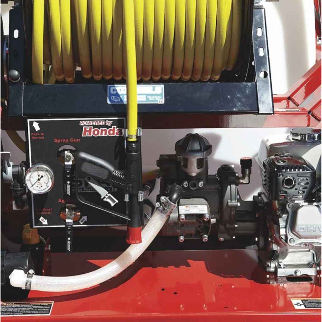 Close-up of a Northstar skid sprayer 160cc gx160 with a Honda spray gun attachment on a red machine.