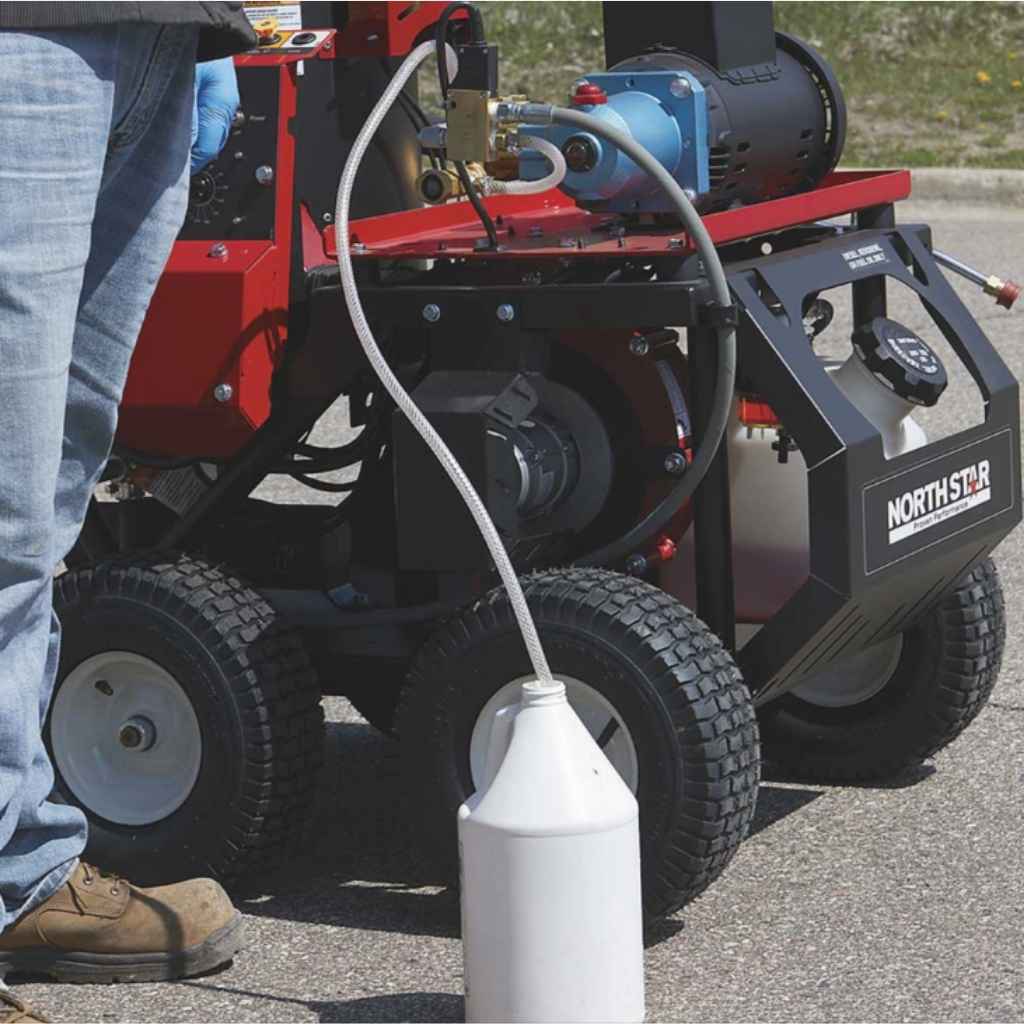 Person using a northstar 2750 hot water pressure washer during the daytime