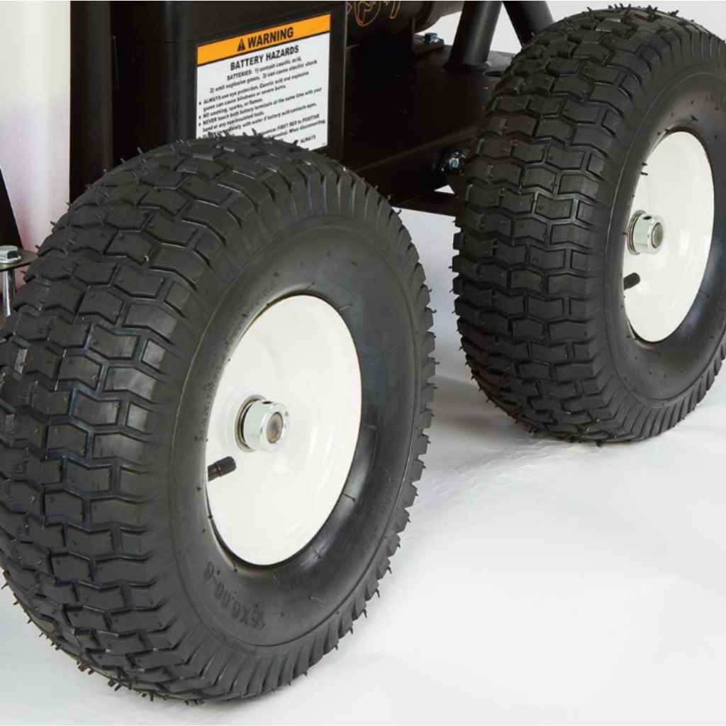 Close-up of large black tires with white rims on a northstar 3500 hot water 3.5 gpm pressure washer on a white background