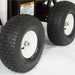 Close-up of large black tires with white rims on a northstar 3500 hot water 3.5 gpm pressure washer on a white background