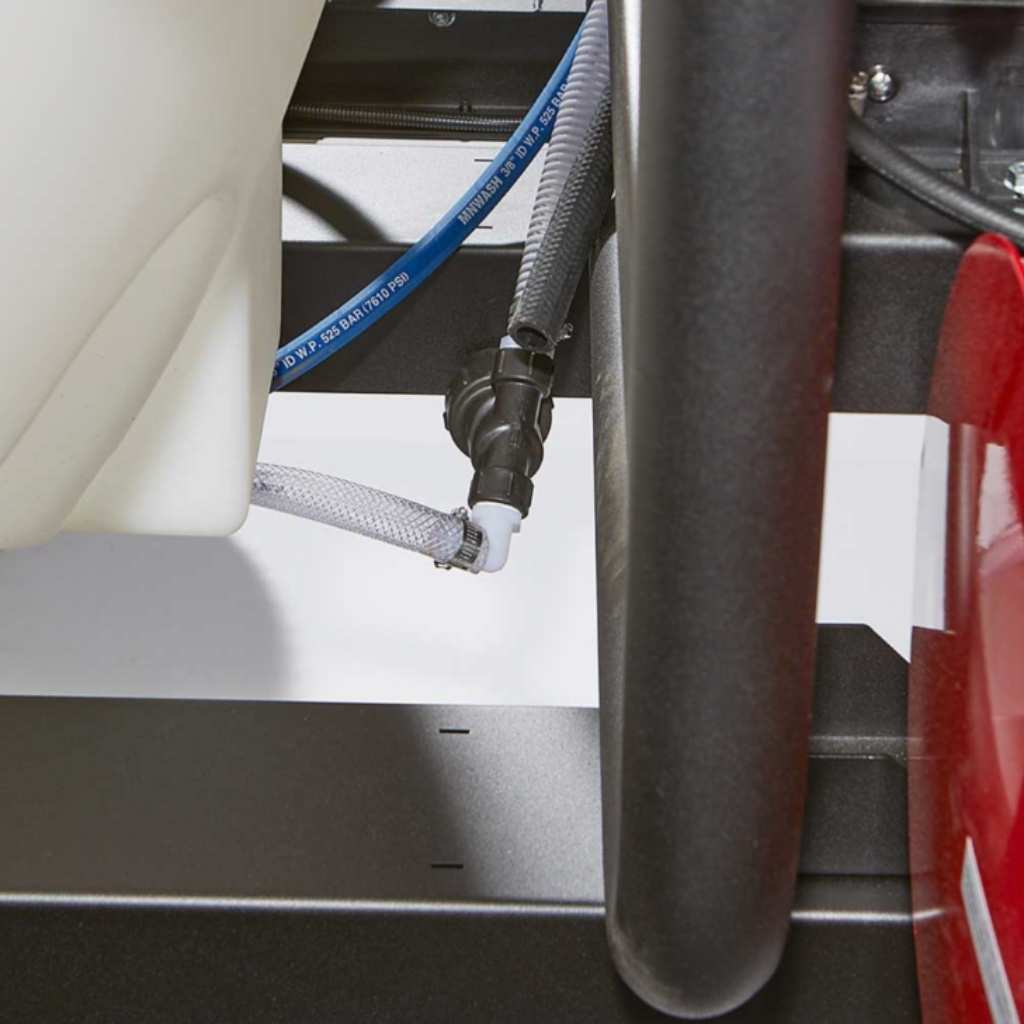 Close-up of a hose connection on a northstar 4000 psi hot water pressure washer trailer, with a focus on the plumbing details.