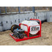 NorthStar 55 Gallon Skid Sprayer 180cc on a construction site with a concrete wall in the background.